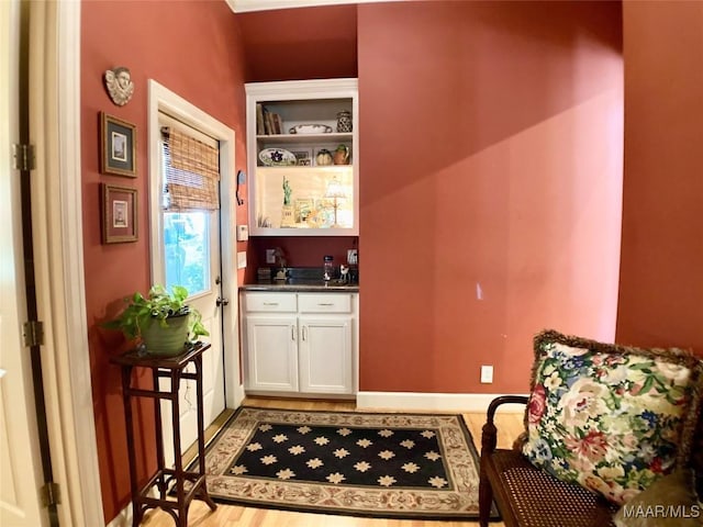 bar with baseboards and wet bar