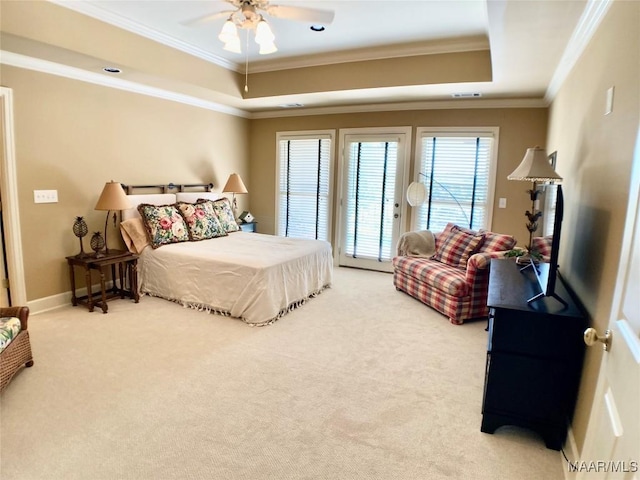 bedroom featuring a raised ceiling, carpet floors, crown molding, and access to outside