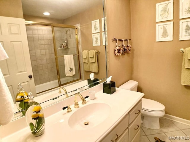 full bathroom featuring toilet, vanity, a shower with door, and tile patterned flooring