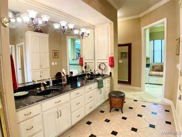 bathroom with a notable chandelier, tile patterned floors, double vanity, ornamental molding, and a wealth of natural light