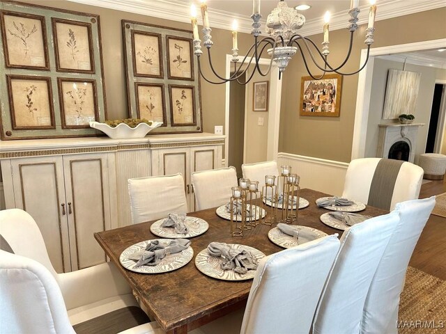 dining area with a notable chandelier, dark hardwood / wood-style floors, and ornamental molding