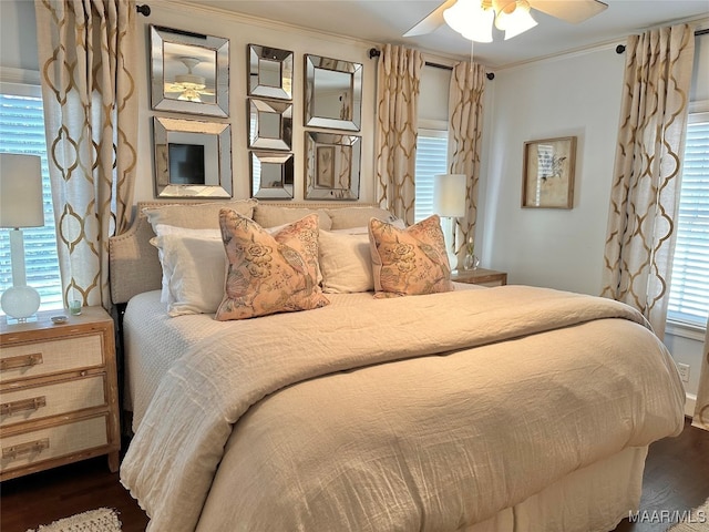 bedroom featuring ornamental molding, dark wood-type flooring, and ceiling fan