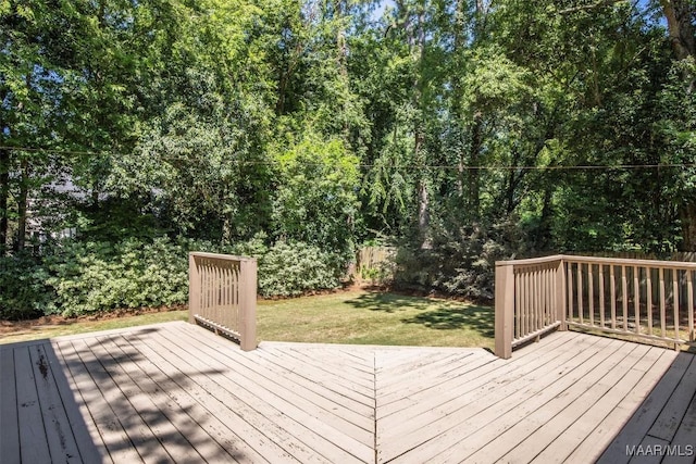 wooden deck with a lawn