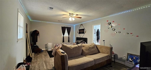 bedroom featuring ceiling fan, hardwood / wood-style flooring, a textured ceiling, and ornamental molding