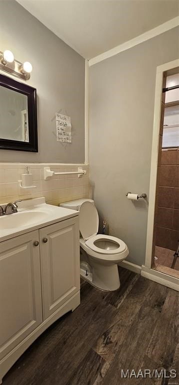 bathroom with toilet, tile walls, backsplash, hardwood / wood-style flooring, and vanity