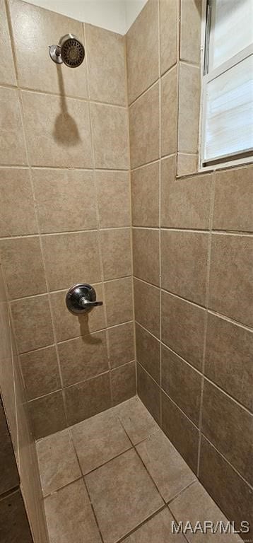 bathroom with a tile shower