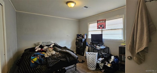 bedroom featuring crown molding and hardwood / wood-style floors