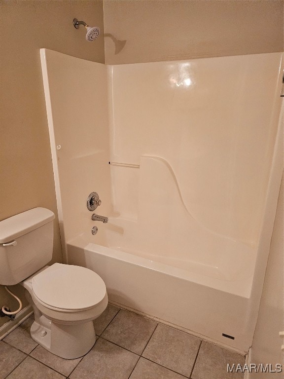 bathroom with  shower combination, tile patterned flooring, and toilet