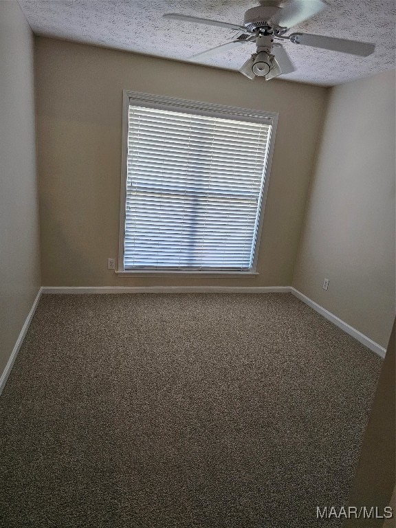 unfurnished room with ceiling fan, carpet flooring, and a textured ceiling