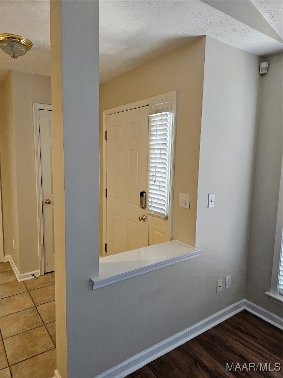 tiled entrance foyer with a textured ceiling