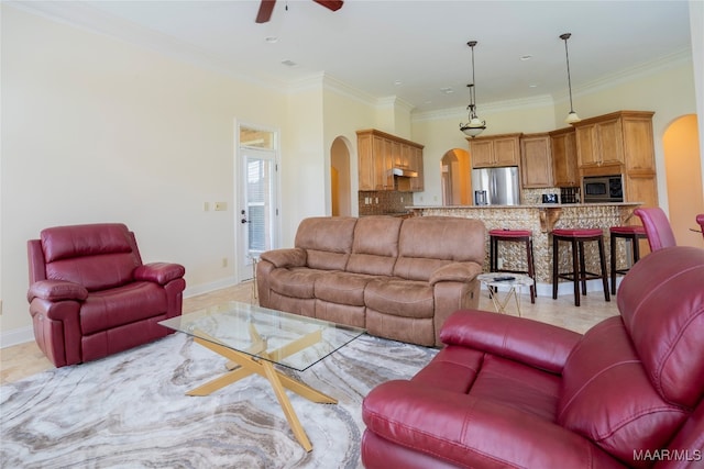 living room featuring ceiling fan and ornamental molding