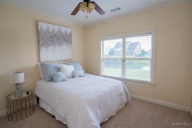 bedroom with ornamental molding, light colored carpet, and ceiling fan