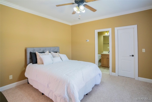 carpeted bedroom with ensuite bath, ceiling fan, crown molding, and sink