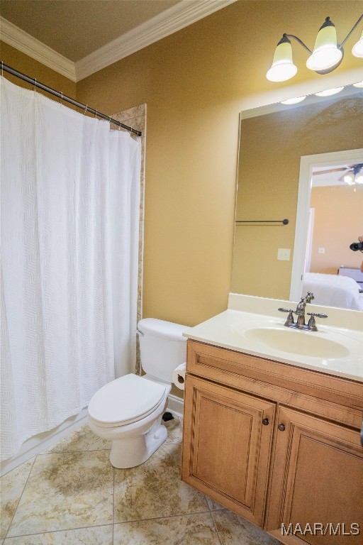 bathroom with tile patterned flooring, vanity, toilet, and crown molding