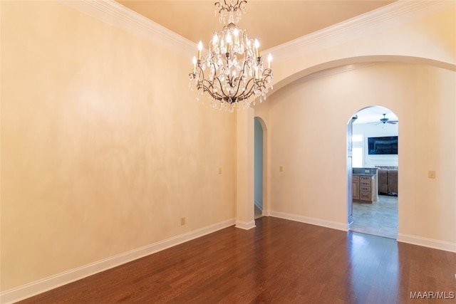 empty room featuring ceiling fan with notable chandelier, dark wood-type flooring, and crown molding