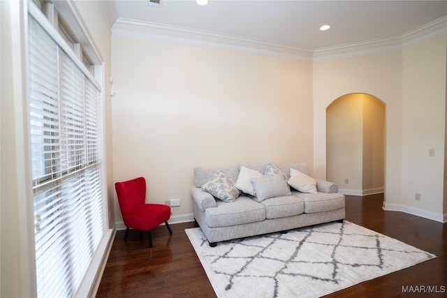 living room with dark hardwood / wood-style flooring and ornamental molding