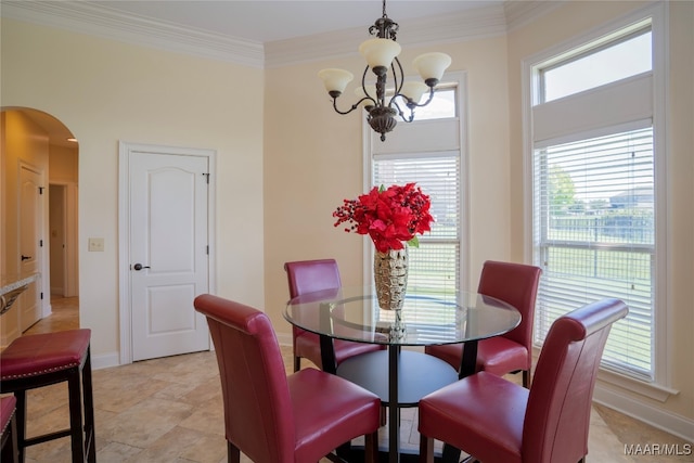 dining space with plenty of natural light, a notable chandelier, and ornamental molding