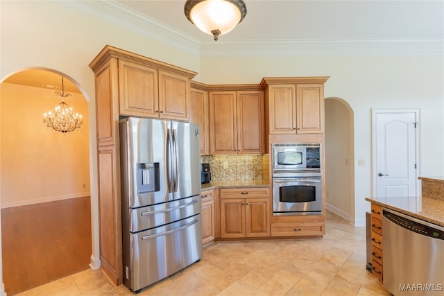 kitchen with light hardwood / wood-style flooring, a notable chandelier, crown molding, light stone countertops, and appliances with stainless steel finishes