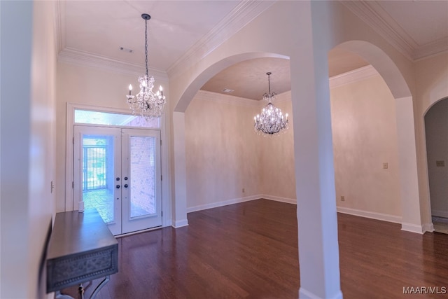 foyer featuring dark wood-type flooring, a chandelier, french doors, and ornamental molding