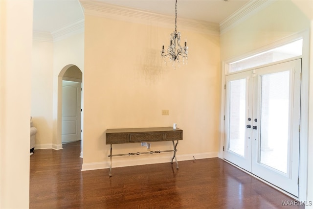 interior space featuring dark hardwood / wood-style floors, crown molding, and a notable chandelier