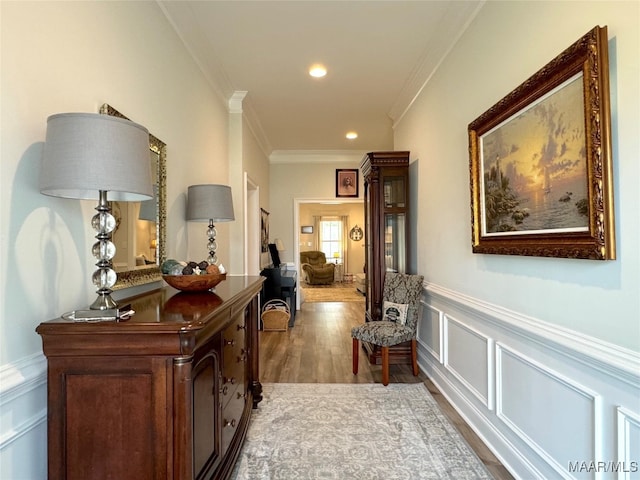 hallway with hardwood / wood-style floors and crown molding