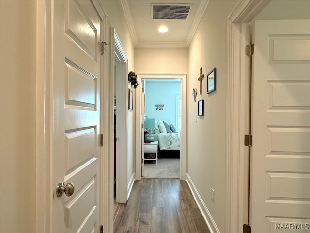 hallway featuring dark hardwood / wood-style flooring and crown molding