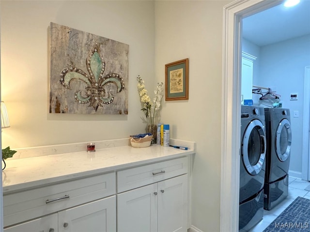 washroom with cabinets, light tile patterned flooring, and washer and clothes dryer