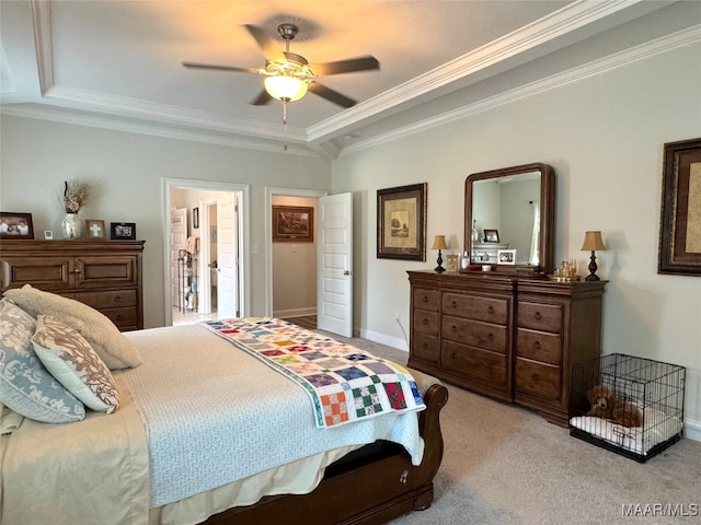 carpeted bedroom featuring ceiling fan, crown molding, and a tray ceiling