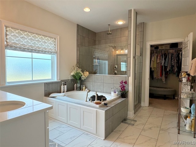 bathroom featuring independent shower and bath, vanity, and tile patterned floors