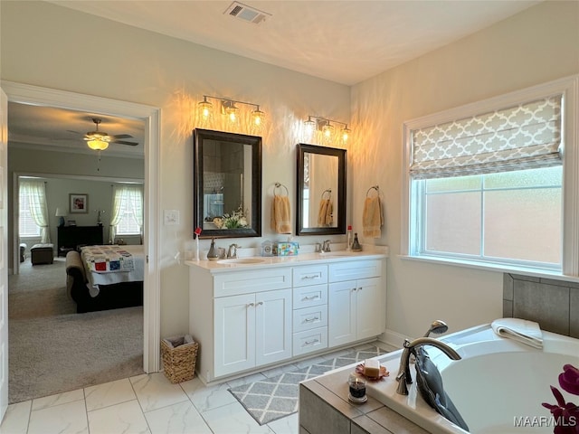 bathroom featuring tile patterned floors, ceiling fan, a tub to relax in, and dual bowl vanity