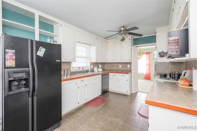 kitchen featuring a healthy amount of sunlight, white cabinets, and black appliances