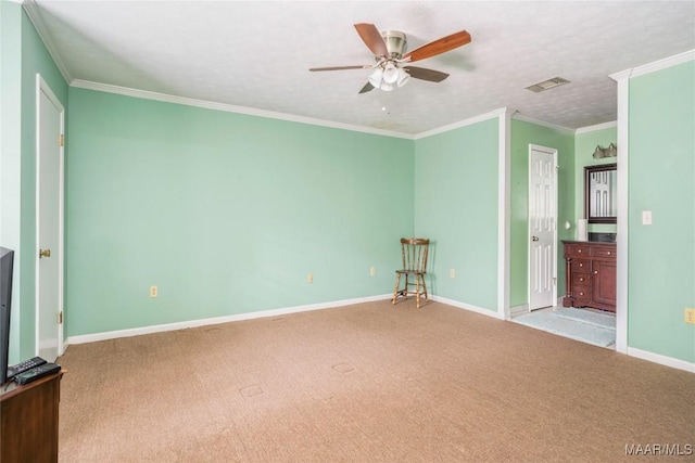 unfurnished bedroom featuring ensuite bath, ceiling fan, ornamental molding, a textured ceiling, and light colored carpet