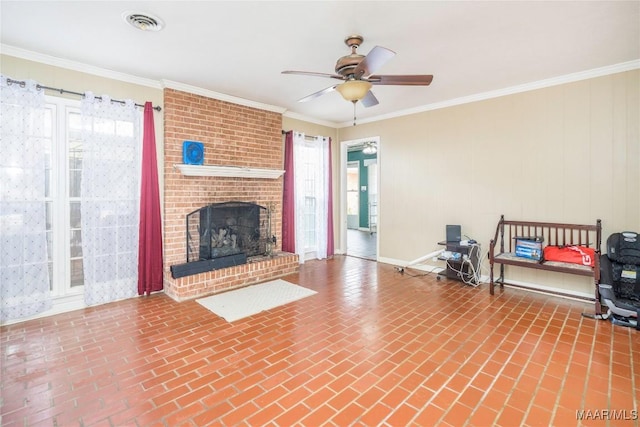 unfurnished living room with a brick fireplace, ceiling fan, and crown molding