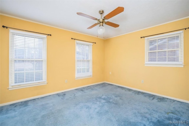 carpeted spare room featuring ceiling fan and ornamental molding