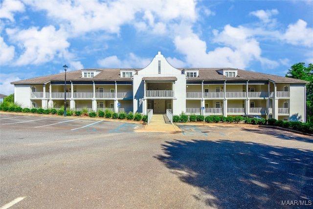 view of property featuring uncovered parking