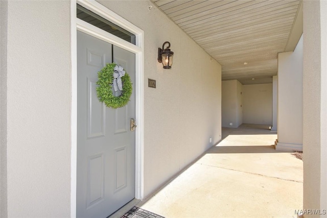 doorway to property with stucco siding