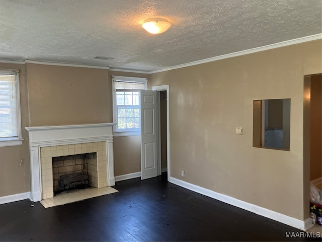 unfurnished living room with a textured ceiling, crown molding, hardwood / wood-style floors, and a tile fireplace