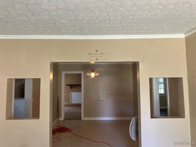 interior space with ornamental molding and a textured ceiling