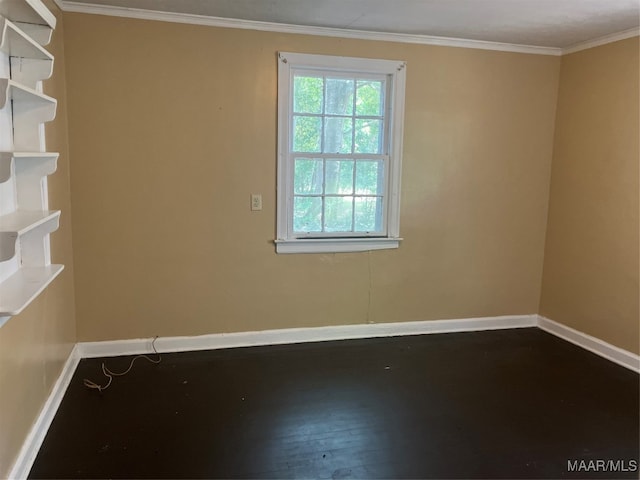 empty room with hardwood / wood-style floors and crown molding