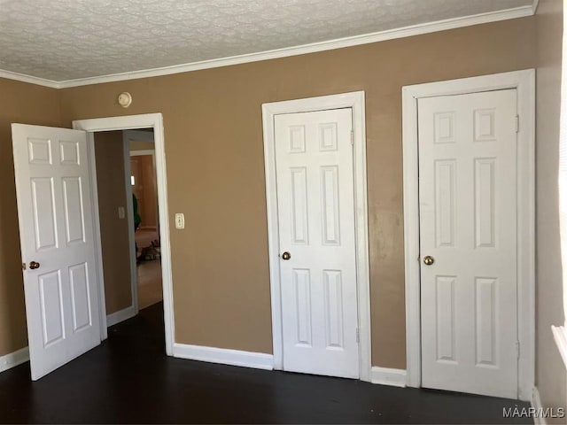 unfurnished bedroom featuring crown molding, dark wood-type flooring, and a textured ceiling