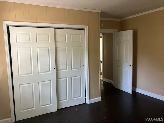 unfurnished bedroom with crown molding, a closet, and a textured ceiling