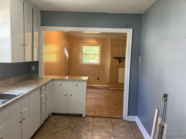 kitchen with light tile patterned flooring and white cabinets