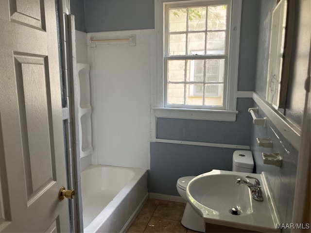 bathroom with sink, toilet, and tile patterned floors