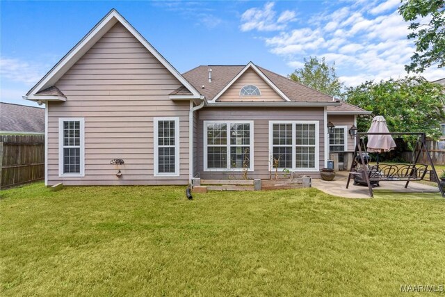 back of house featuring a patio and a yard