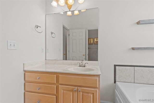 bathroom with a washtub and vanity