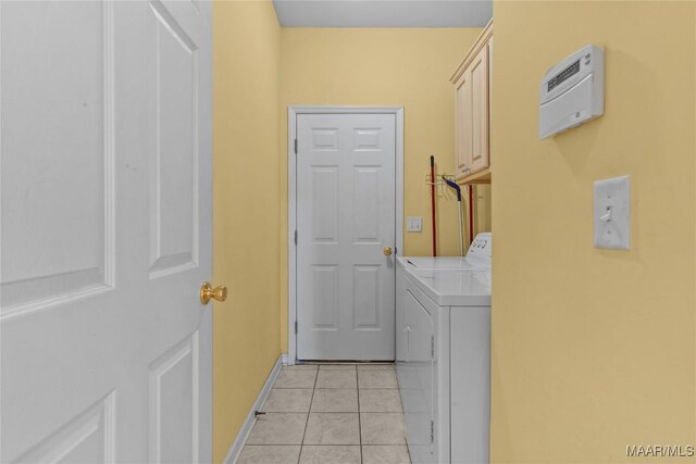 laundry area with cabinets, separate washer and dryer, and light tile patterned floors