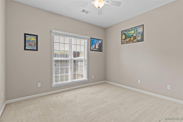 spare room with ceiling fan and carpet flooring