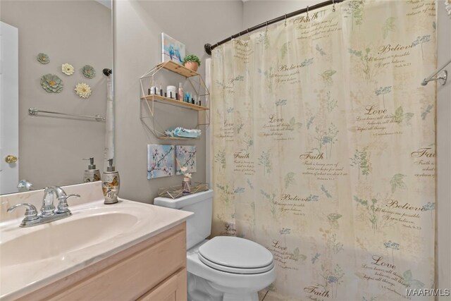 bathroom featuring tile patterned floors, toilet, and vanity