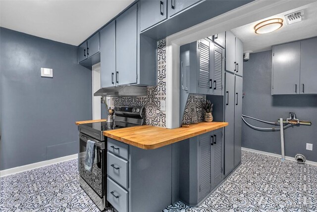 kitchen with butcher block countertops, range with electric stovetop, and light tile patterned floors