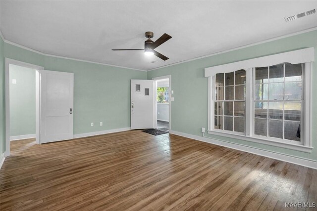 unfurnished living room with ceiling fan, crown molding, and wood-type flooring